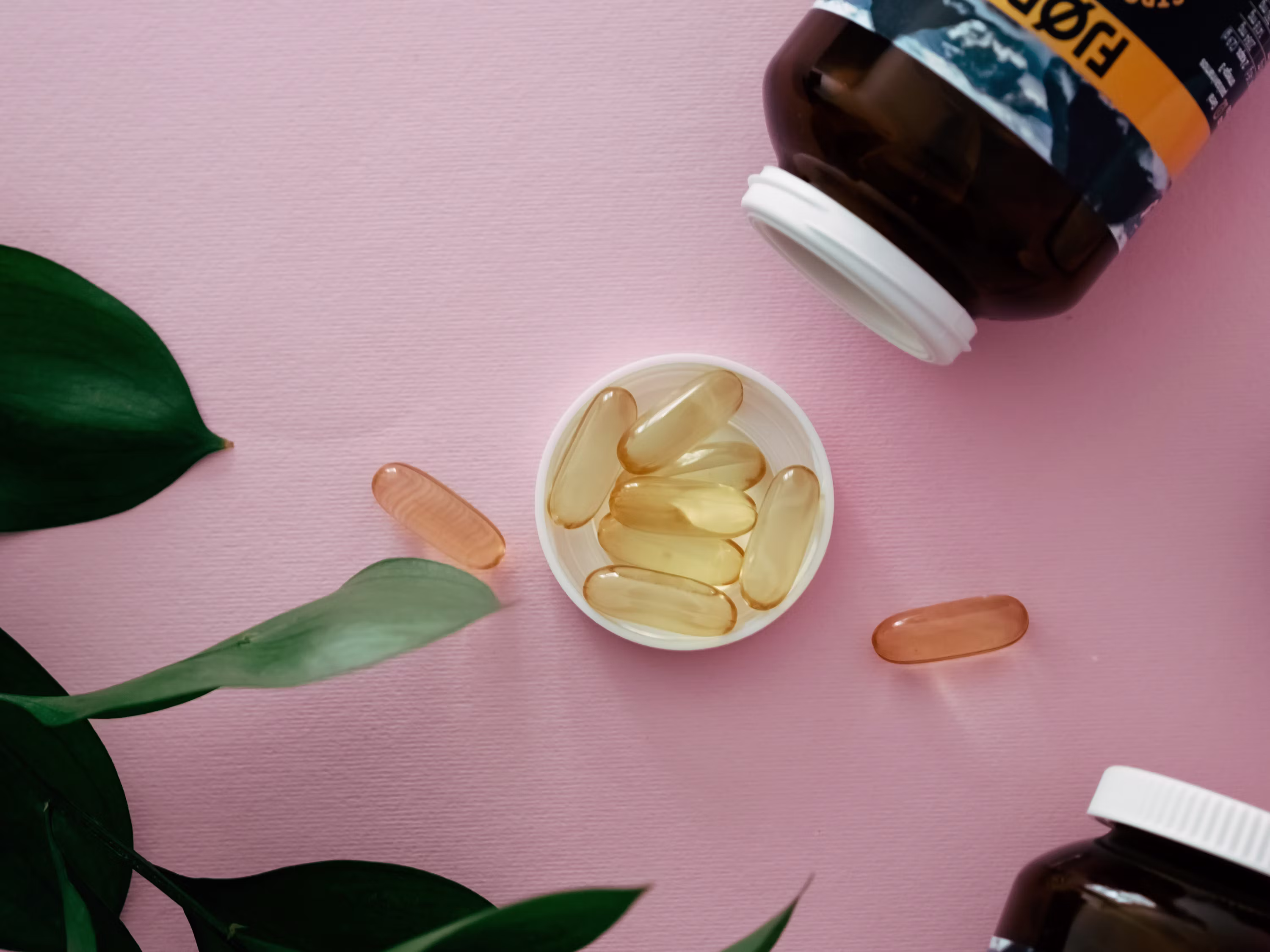 a bowl of fish oil next to a bottle of fish oil